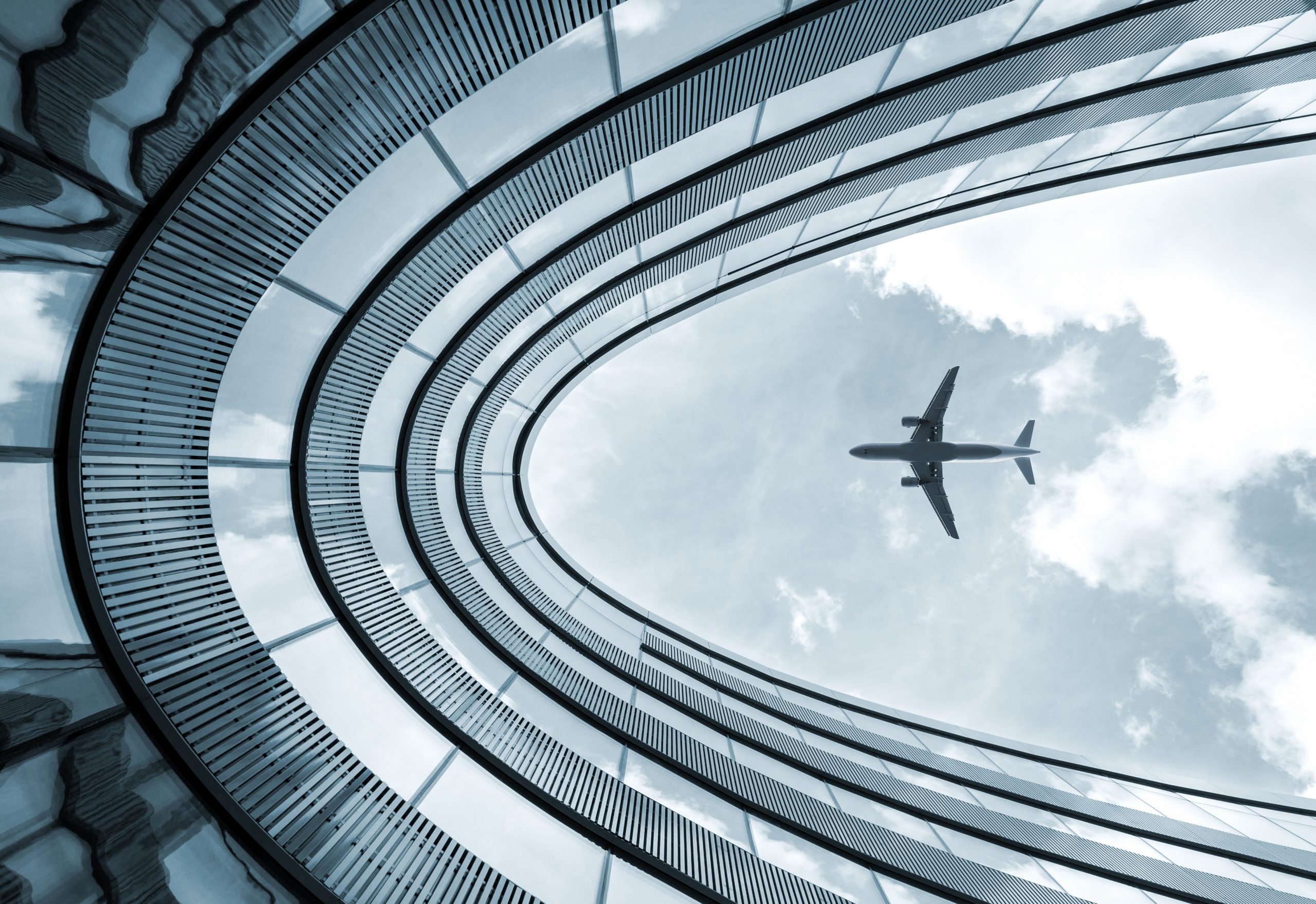 Modern architecture building with landing airplane